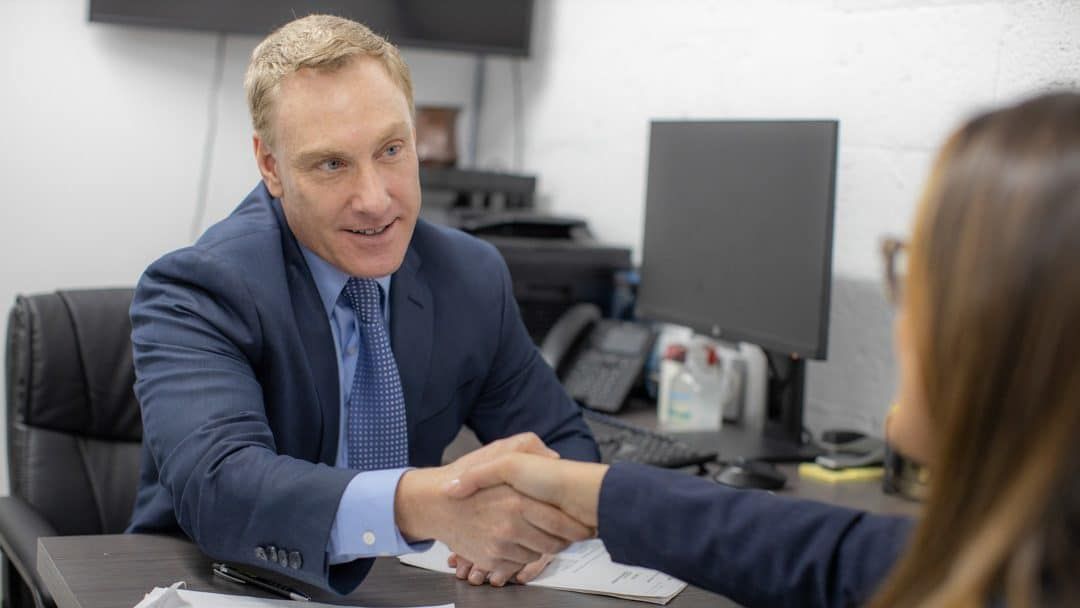 an image of a bronx lawyer talking with a client about car accident